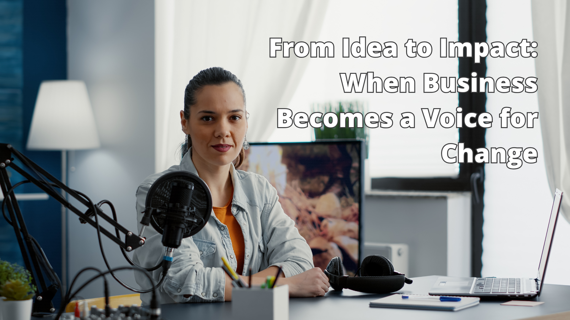 When Business Becomes a Voice for Change Woman sitting at a desk with a microphone and notebook, reflecting on her journey from hardship to impact